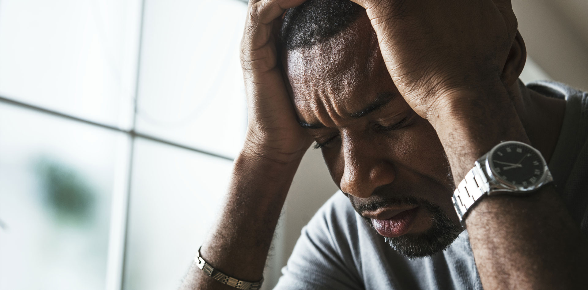 man holding head depressed