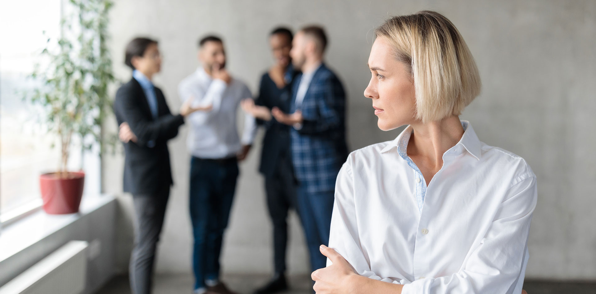 Group of people talking behind a woman's back