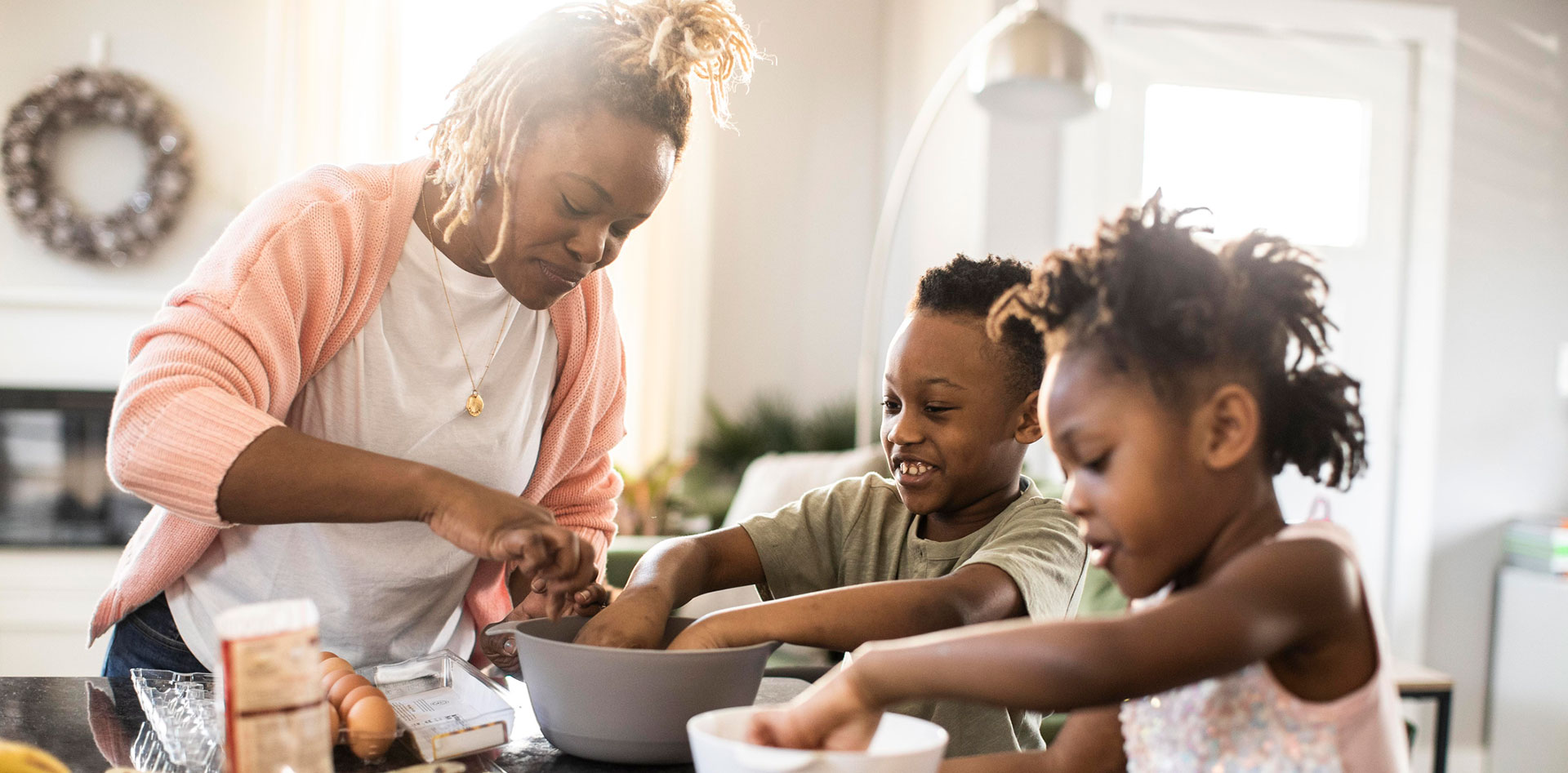 A mom cooking with her two children