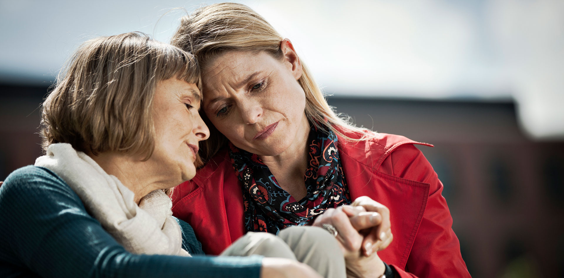 Mature middle aged woman caring for her elderly mother.